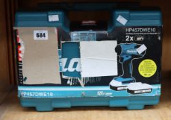 An as new Makita cordless combo drill and 74 piece bit (HP457DWE10).