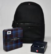 As new Tommy Hilfiger items; an Essential backpack, bracelet and tin containing four pairs of