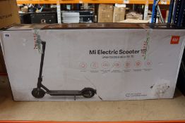A boxed Xiaomi 1S Electric Scooter in dark grey (Box opened).
