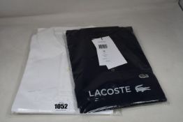 An as new Lacoste white polo shirt (FR 5 - RRP £80) and blue polo (Size 36 - RRP £105).