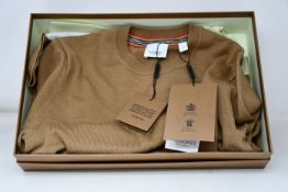 An as new Burberry brown sweater (XS).