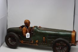 A plastic vintage race car ornament.