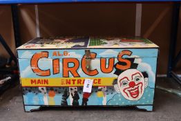 A wooden chest painted with a circus theme.