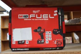 An as new Milwaukee M18 FPP2A2-502X Combi Drill and Impact Driver set with batteries, charger and