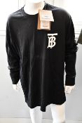 An as new Burberry Atherton long sleeved monogramed top in black (XS - RRP £370, requires washing).