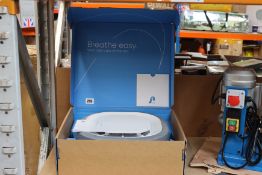 A boxed Aura Air Rev 1.0 air purifier (Smart air purification and monitoring that disinfects 99.9%
