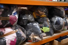 Nine bags of assorted clothing and related items.