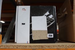 A boxed as new Staub Cast Iron Round Cocotte in cherry (24cm).