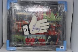 An as new signed and framed Jerzy Dudek goalkeeper glove (BCVA do not authenticate the signature).