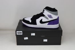 A pair of as new Nike Air Jordan 1 Mid SE (UK 7).