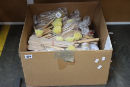 A box of assorted as new wooden cooking utensils and cleaning utensils.