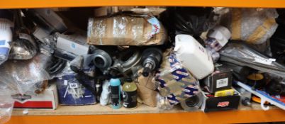 A shelf of car/motorbike parts and related items.