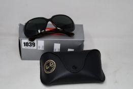 A pair of as new Ray Ban sunglasses.