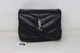 An as new YSL small handbag in black.