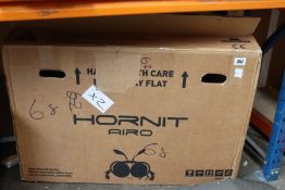 A boxed Hornit Airo Kid's Balance Bike in yellow.