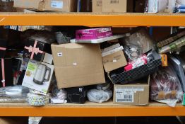 A shelf of household items to include souvenirs and kitchen ware.