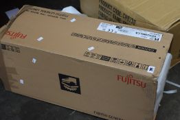 A boxed Fujitsu wall mounted indoor air conditioning unit (Model: ASYG18KLCA).