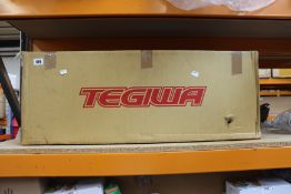 A boxed Tegiwa T-4077080 K-Swap header exhaust.