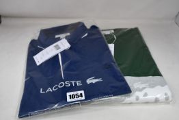 An as new Lacoste blue polo shirt (Size FR 4 - RRP £110) and Lacoste sweatshirt in green (FR 4 - RRP