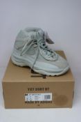 A pair of boxed as new Adidas Yeezy Desert Boots in Salt (UK 5.5).