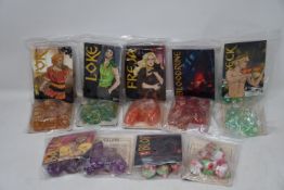 A large quantity of Dungeons and Dragons/gaming dice (Approximately 60 packets, 5 dice per packet).