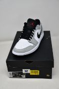 A pair of as new Nike Air Jordan 1 Low in smoke grey (UK 8.5).