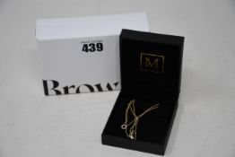 An as new Browns 9k small disk pendent necklace with box.