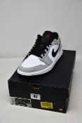 A pair of as new Nike Air Jordan 1 Low in smoke grey (UK 9).