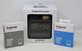 A boxed as new Polaroid 600 OneStep Close Up Refurbished Vintage Instant Camera, two boxes of 8
