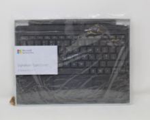 A boxed as new Microsoft Surface Pro Signature Type Cover in Alcantara Light Charcoal (FFP-00143