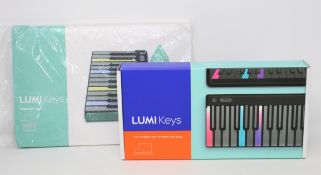 A boxed as new Roli Lumi Keys midi keyboard (Box opened) and a boxed as new Lumi Snapcase in Aqua (