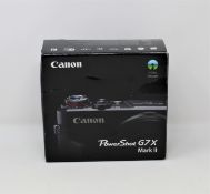 A boxed as new Canon PowerShot G7X Mark II Digital Camera in Black (Box opened, UK plug adaptor