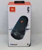 A boxed as new JBL Flip 5 Waterproof Portable Bluetooth Speaker in Blue (Box sealed, ssome damage to