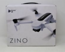 A boxed as new Hubsan Zino Folding Quadcopter Drone (UK plug adapter required).
