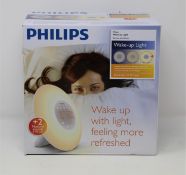 A boxed as new Philips Wake-up Light FM Radio Alarm Clock With Sunrise Simulation (Box sealed).