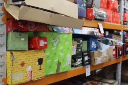 A shelf of assorted car parts to include coil springs, alternators, water pumps, brake discs, timing