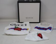 An as new Gucci baby grow, hat and bib set (6-9 months).