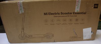A boxed Xiaomi Essential Electric Scooter in black.