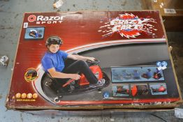 A boxed as new Razor Sport crazy cart electric drift cart in red (Boxed damaged and damp).