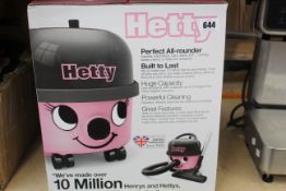 A boxed as new Hetty 160 Hoover in pink and black.
