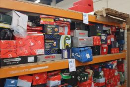 A shelf of assorted car parts to include starter motors, coil springs, brake discs alternators,