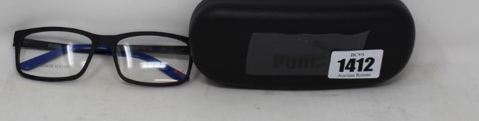 Two pairs of as new Puma black framed glasses with blue tips to arms with cases (Clear lenses).