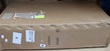 A boxed baby stroller in beige.