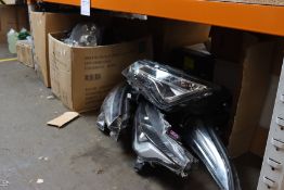 A quantity of pre-owned genuine car headlights.