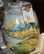 A handmade vase picturing an Italian landscape and a ceramic bauble from Ceramiche Laureanti.