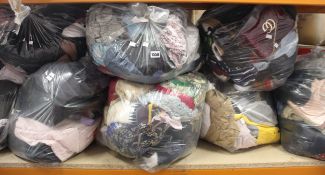 Eight bags of assorted clothing and related items.