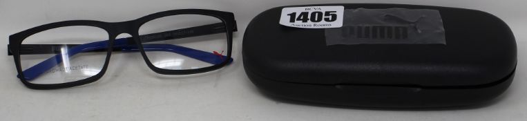 Three pairs of as new Puma black framed glasses with blue tips to arms with cases (Clear lenses).