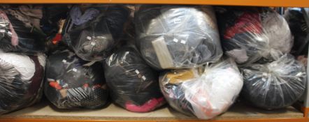 Nine bags of assorted clothing and related items.