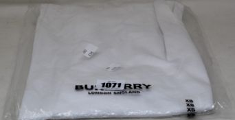 An as new Burberry Atherton long sleeved monogramed top in white (XS - RRP £370).