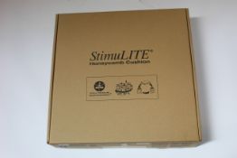 A boxed as new StimuLite Contoured XS Pressure Relief Wheelchair Cushion (17 x 18).